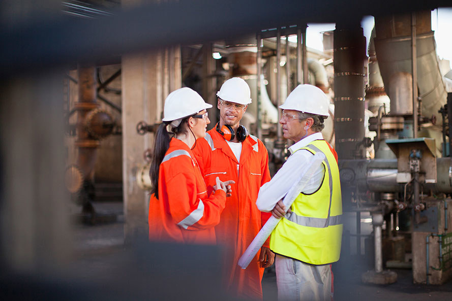 Workers Talking At Oil Refinery